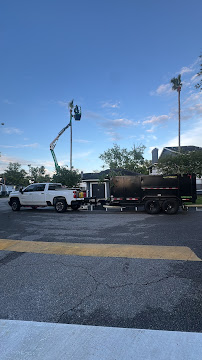 Green Canopy truck and chip trailer staged at job site